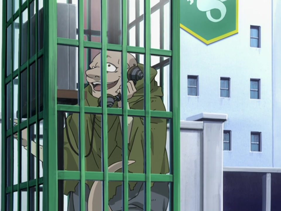 A screencap of the 2003 anime. Bido smiles widely as he talks on the phone.'
